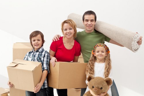 Local removal team organising a move with boxes and furniture
