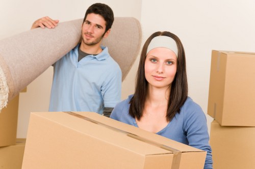 Professional movers handling boxes and furniture in Shacklewell