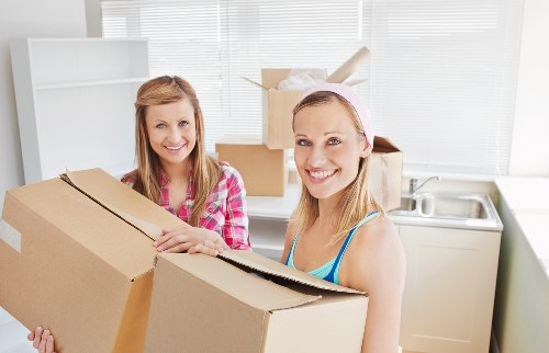 Professional movers loading household items for transport